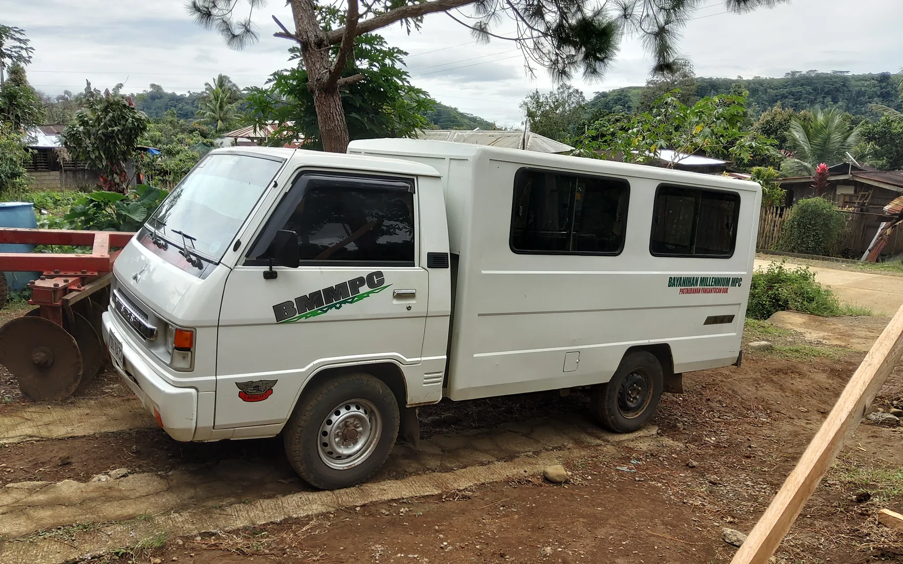 White service vehicle marked BMMPC in Pigtauranan, Pangantucan, Bukidnon